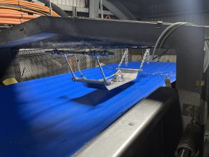 Moisture meter on sled above conveyor belt